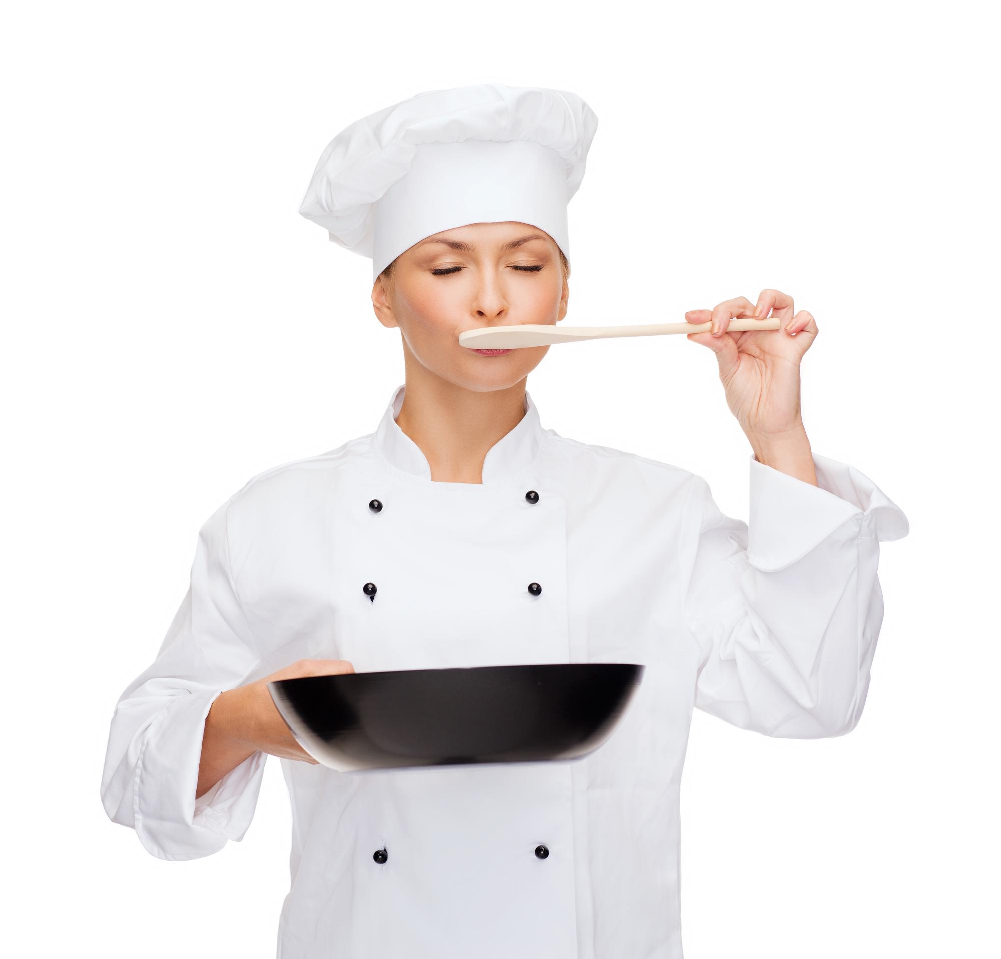 Chef adjusting seasoning in modern kitchen